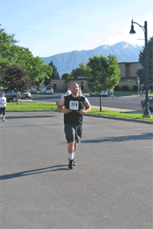 Jeremy a few seconds before he finished. Jeremy ran this race with us. It was his first race ever. Way to go Jer!